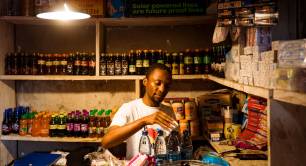 shopkeeper with lamp above his counter