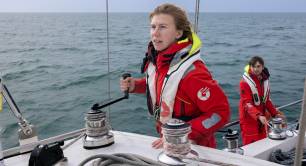 Sea Ranger Service staff member steering a ship in the sea